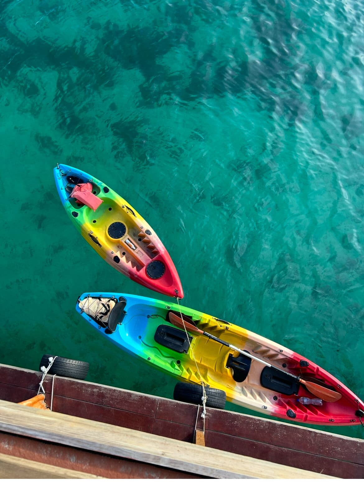 Kayaks pulled up by a floating bar in Bocas del Toro